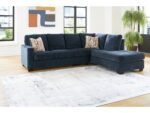 Blue fabric L-shaped sectional sofa with chaise in modern living room.