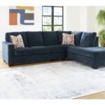 Blue fabric L-shaped sectional sofa with chaise in modern living room.